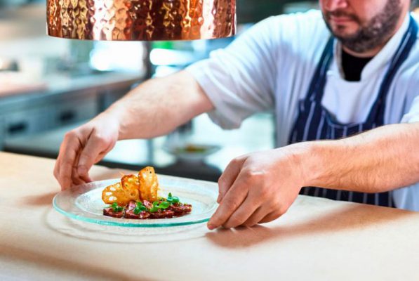 image of a chef serving food