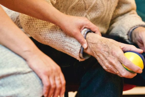 image of a person supporting an elderly person