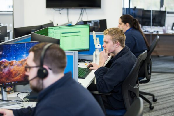 Image of Central Technology staff members at their computers working